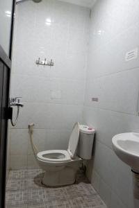 a bathroom with a toilet and a sink at Hy ReDz in Palopo +23 photos