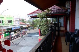 a balcony of a building with a swimming pool at Hy ReDz in Palopo