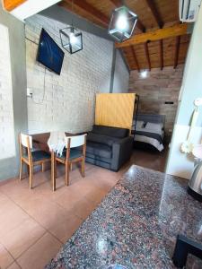 a living room with a couch and a table and chairs at FRIENDLY Studio in Maipú
