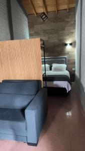 a bedroom with a bed and a couch in it at FRIENDLY Studio in Maipú