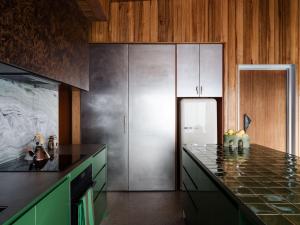 a kitchen with a counter top and a refrigerator at Threefold in Swansea
