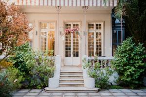 a house with a white door and stairs at Matildas Hotel Boutique in Santiago