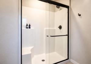 a shower with a glass door in a bathroom at Kwem Homes in Salem