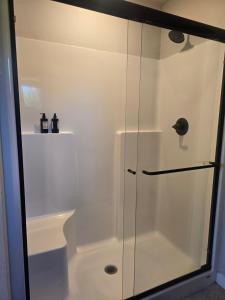 a shower with a glass door in a bathroom at Kwem Homes in Salem +1 photo