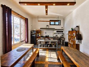 a kitchen with two wooden benches in a room at Hostal Licanantay in Valparaíso
