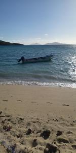 a boat sitting in the water on a beach at Nanz's Homestay in Ngunu