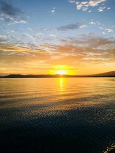 a sunset over a large body of water at Nanz's Homestay in Ngunu