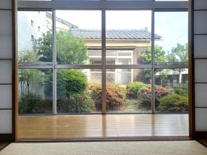 an open window with a view of a garden at 一棟貸切民宿Saisai 3部屋 in Sakai
