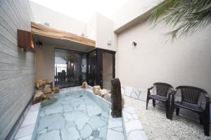 a hot tub in the backyard of a house at Dormy Inn Miyazaki Natural Hot Spring in Miyazaki