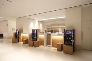 a room with a bunch of pay phones in a building at Dormy Inn Miyazaki Natural Hot Spring in Miyazaki