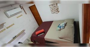 a small room with a bed and a window at Casa Completa - Macondo Beach House in Rincón