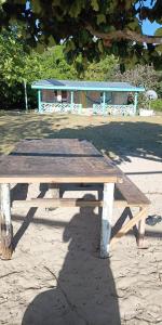 a wooden picnic table sitting on top of a field at Nanz's Homestay in Ngunu +4 photos