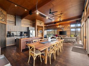 a kitchen and dining room with a wooden table and chairs at Ridge Way Views in Mansfield