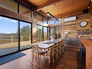 a dining room with a table and chairs and a clock at Ridge Way Views in Mansfield +10 photos