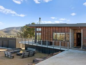 a house with a fire pit and benches in front of it at Ridge Way Views in Mansfield