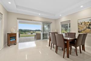 a dining room with a table and chairs at Mole Hill Farmhouse in Lovedale
