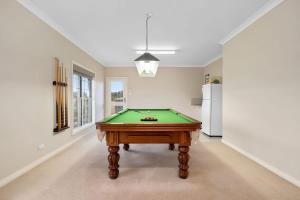 a pool table in the middle of a room at Mole Hill Farmhouse in Lovedale