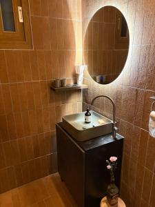 a bathroom with a sink and a mirror at 시골마을 한옥독채 '가니재' in Ssangjŏng-ni