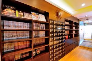a library with many shelves of dvds at Spa&Capsule Hotel Grandpark Inn Kitasenju in Tokyo