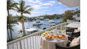 a table with food on a balcony with a view of a marina at Balmoral Jetty Estate in Balmoral