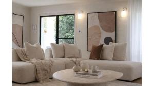 a living room with two couches and a table at Balmoral Jetty Estate in Balmoral
