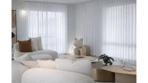 a living room with a teddy bear sitting on a couch at Balmoral Jetty Estate in Balmoral