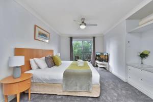 a bedroom with a large bed and a television at Villa 3br Chianti Villa located within Cypress Lakes Resort in Pokolbin