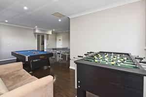 a living room with a pool table and billiards at Beggars Bridge Vineyard Homestead with pool and tennis in Rothbury