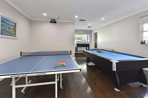 a ping pong table in a room with a pool table at Beggars Bridge Vineyard Homestead with pool and tennis in Rothbury +31 photos