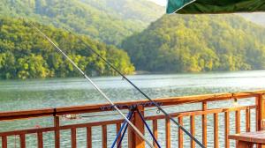 a fishing pole on a boat on a lake at Gapyeong Rialto Pension in Gapyeong +2 photos