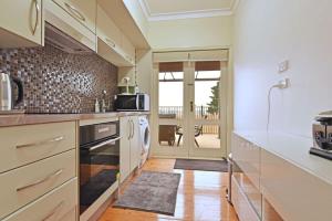 a kitchen with a sink and a stove top oven at King 2 - close proximity to Bimbadgen and Hope Estate concerts in Pokolbin