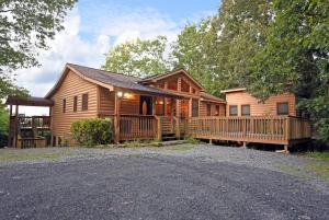 a log cabin with a porch and a driveway at 6BR/5BA Retreat • Hot Tub • Game Room • Treehouse in Blue Ridge