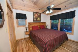 a bedroom with a bed and a ceiling fan at 6BR/5BA Retreat • Hot Tub • Game Room • Treehouse in Blue Ridge