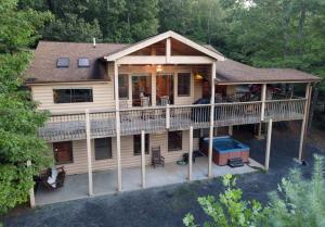 an aerial view of a house with a deck at 6BR/5BA Retreat • Hot Tub • Game Room • Treehouse in Blue Ridge +12 photos