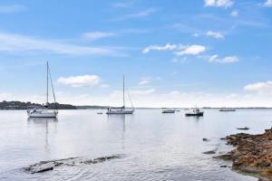 a group of boats floating on a large body of water at Wangi Dreaming in Wangi Wangi