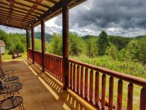 a porch with chairs and a view of the mountains at 2BR/1BA Cabin | Hot Tub | Ocoee River Area | Wifi in Copperhill