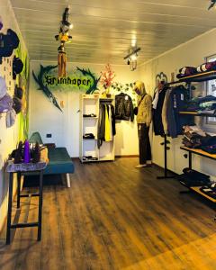 a man is standing in a room with a store at Hostal Perita in San Pedro de Atacama