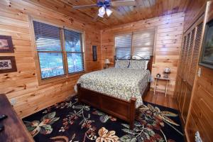 a bedroom with a bed in a log cabin at 4BR/3BA | Hot Tub | Pool Table | Views | Pets ok in Blue Ridge