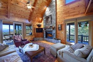 a living room with a fireplace in a log cabin at 4BR/3BA | Hot Tub | Pool Table | Views | Pets ok in Blue Ridge