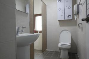a bathroom with a white toilet and a sink at 다락방친구들 in T'ongyŏng