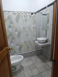 a bathroom with a toilet and a sink at Housing in Mancora in Máncora