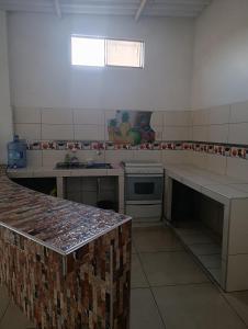 a kitchen with white counters and a counter top at Housing in Mancora in Máncora +14 photos