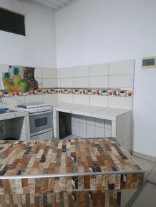 a kitchen with a table in the middle of it at Housing in Mancora in Máncora