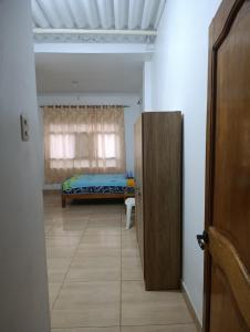 a bedroom with a bed in a room with a door at Housing in Mancora in Máncora