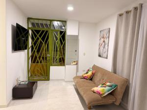 a living room with a couch and a window at Alojamiento Rozo in Girón