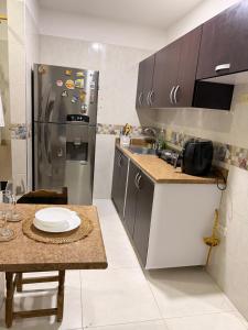 a small kitchen with a stainless steel refrigerator at Alojamiento Rozo in Girón
