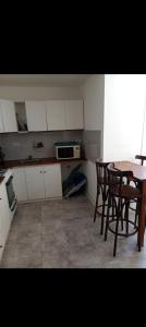 a kitchen with a table and chairs and a microwave at Depto 21 in Miramar