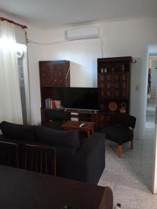 a living room with a couch and a table at Depto 21 in Miramar