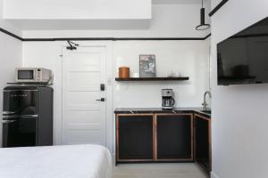 a small kitchen with a sink and a microwave at 1BR Escape Queen Bed WiFi & Kitchenette in San Diego