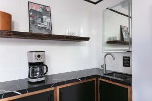 a kitchen with a sink and a coffee maker on a counter at 1BR Escape Queen Bed WiFi & Kitchenette in San Diego